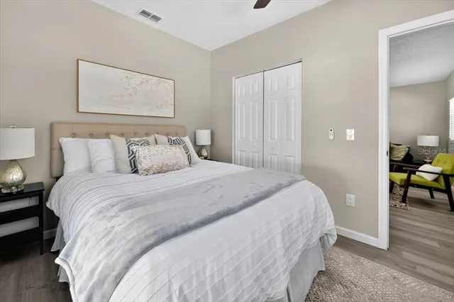 a bedroom with a bed and a painting on the wall