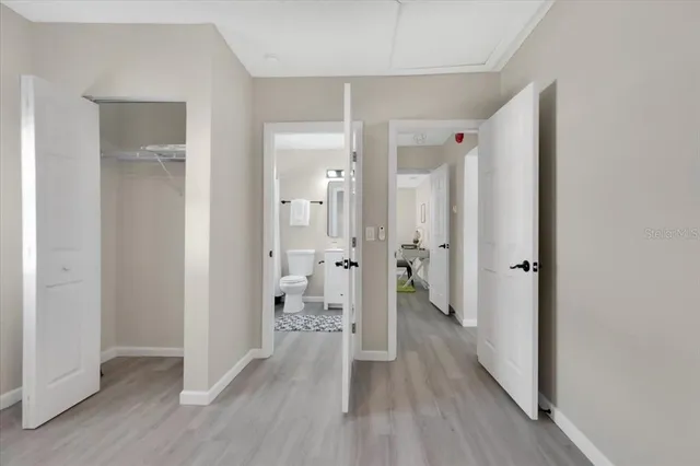 a view of a hallway with wooden floor