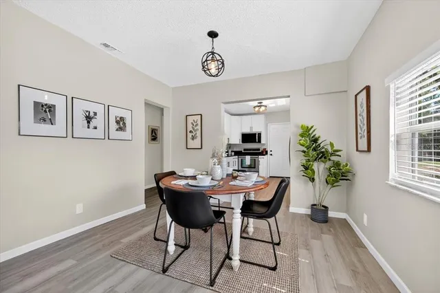 a view of a dining room with furniture and window