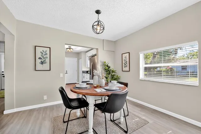 a view of a dining room with furniture window and wooden floor