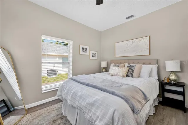 a bedroom with a bed and a window