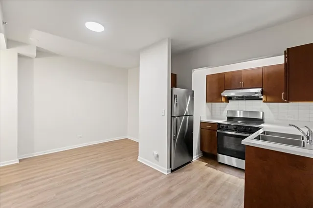 a kitchen with stainless steel appliances granite countertop a refrigerator stove and microwave