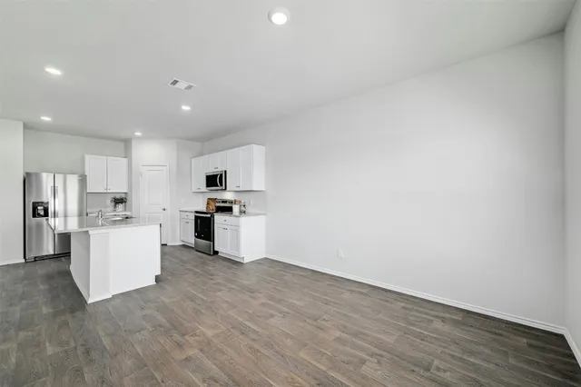 a view of kitchen with furniture and refrigerator