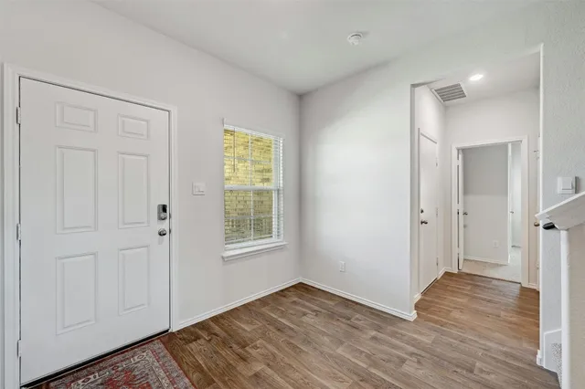 a view of hallway with wooden floor