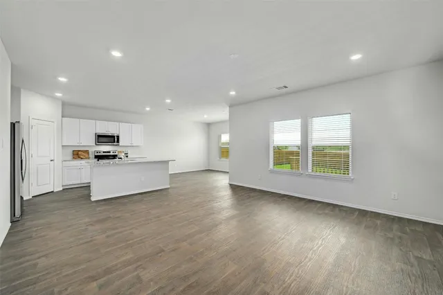 a view of kitchen with refrigerator and window