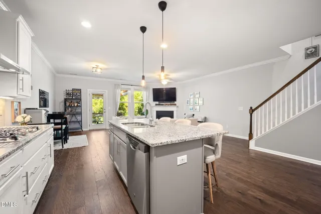 a kitchen with a stove and a wooden floor