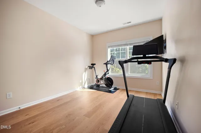 a view of a room with wooden floor and windows