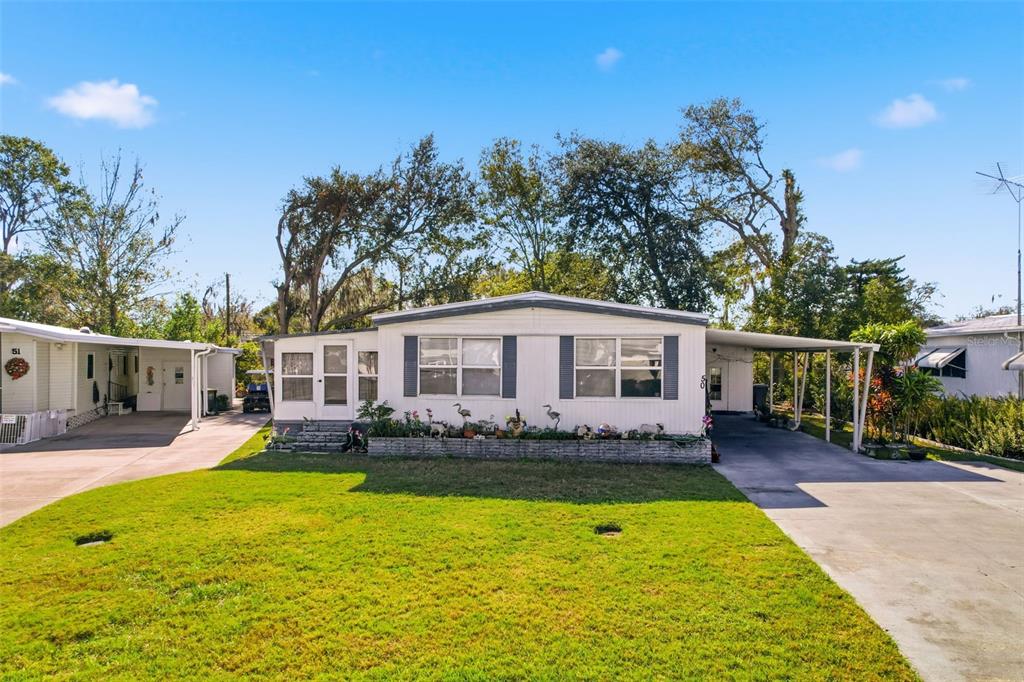 a front view of a house with swimming pool having outdoor seating
