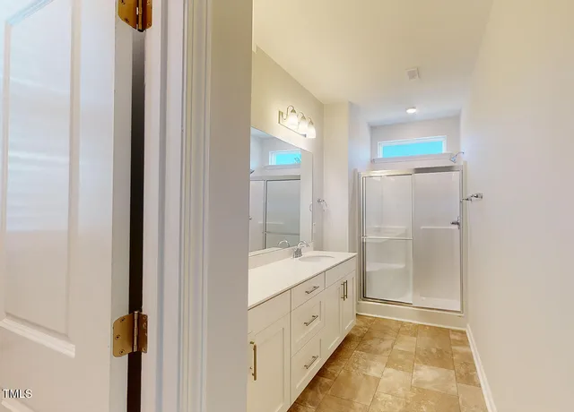 a bathroom with a double vanity sink and mirror