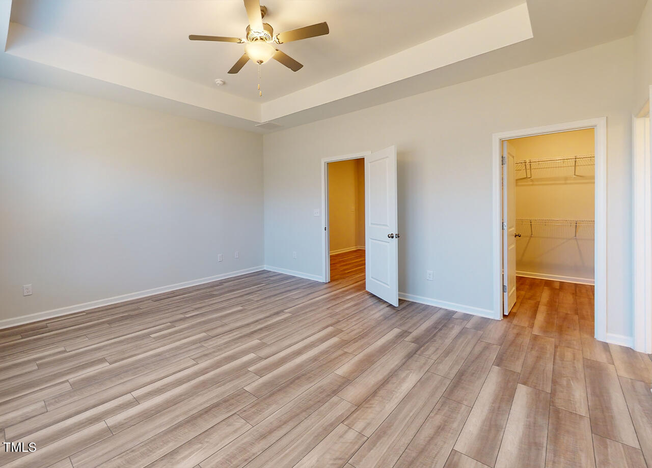 314 Lemon Leaf Place, Unit MANDEVILLA Holly Springs, NC 27540 - Photo 15 of 23 wooden floor in an empty room with a window