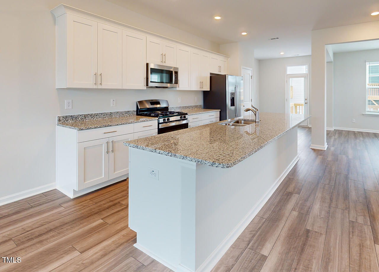 314 Lemon Leaf Place, Unit MANDEVILLA Holly Springs, NC 27540 - Photo 23 of 23 a kitchen with sink a microwave and refrigerator