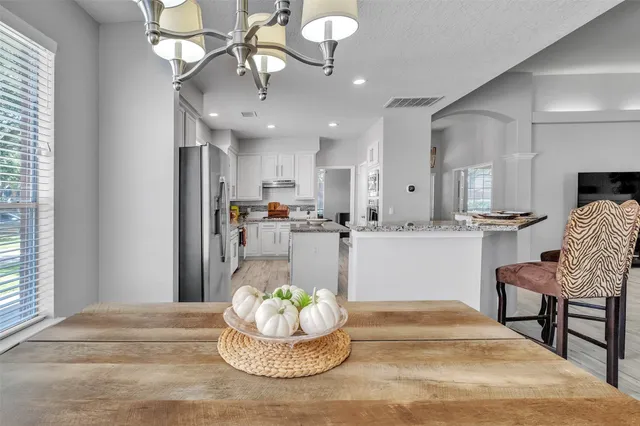 a kitchen with a dining table and chairs