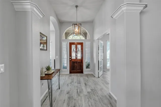 a view of an entryway with wooden floor