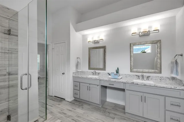 a bathroom with a double vanity sink and mirror