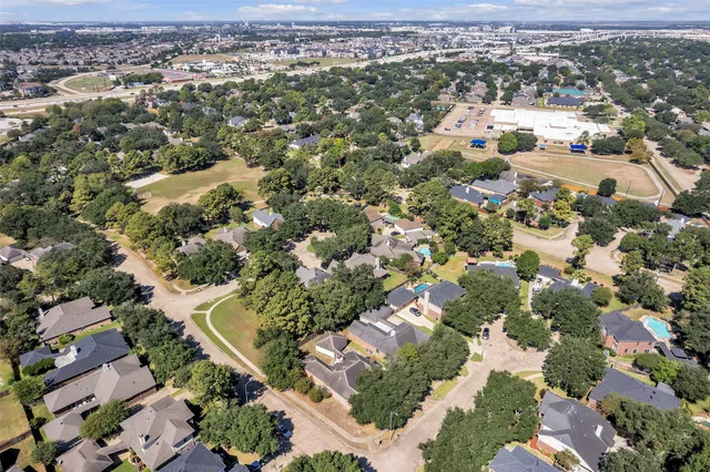 an aerial view of residential houses with outdoor space
