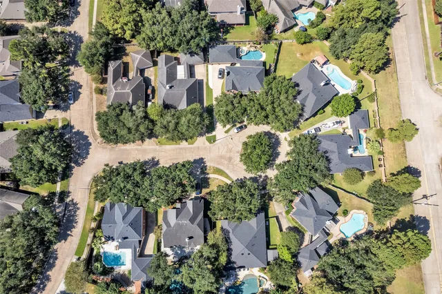 an aerial view of residential houses with outdoor space