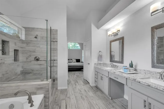 a bathroom with a double vanity sink a mirror and a shower