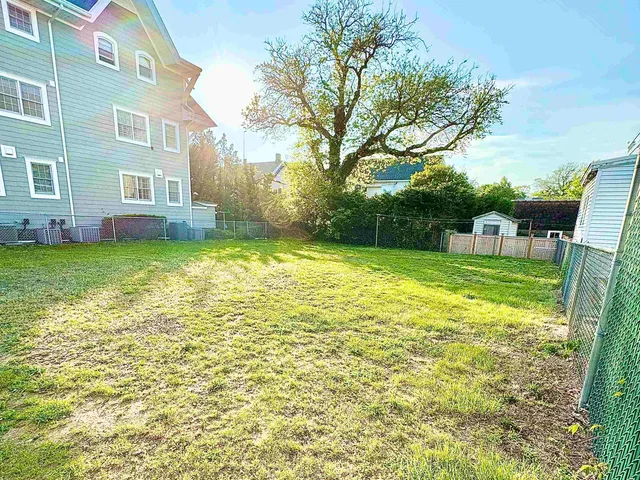 a backyard of a house with barbeque oven table and chairs