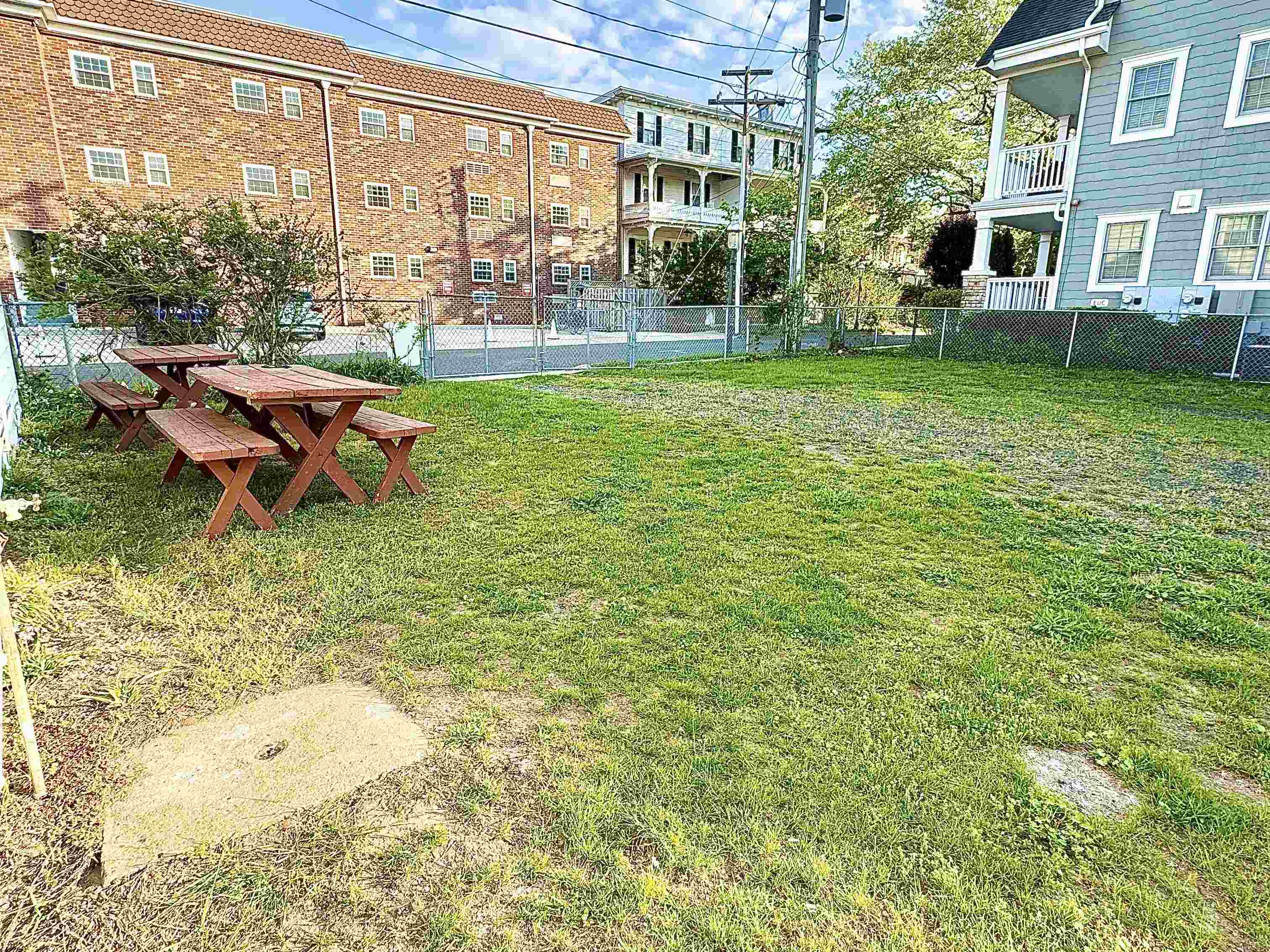 202 Perry Street Cape May, NJ 08204 - Photo 16 of 49 a backyard of a house with barbeque oven table and chairs