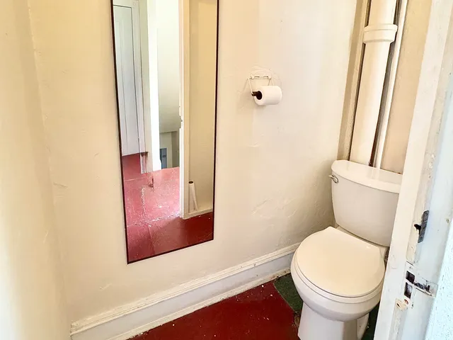 a bathroom with a sink mirror vanity and toilet
