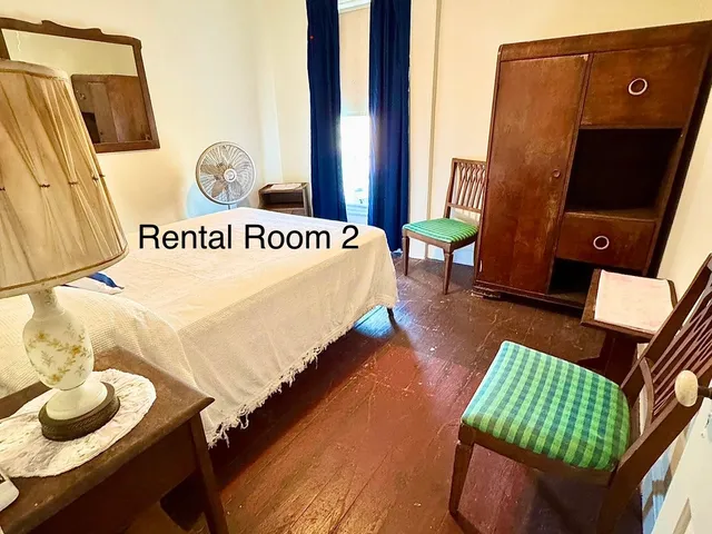 a bedroom with a bed and chair