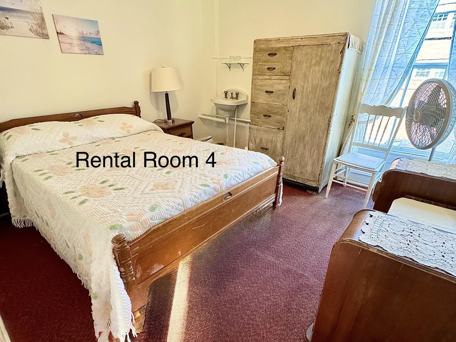 202 Perry Street Cape May, NJ 08204 - Photo 25 of 49 a bed sitting in a bedroom next to a window with pc on the wall