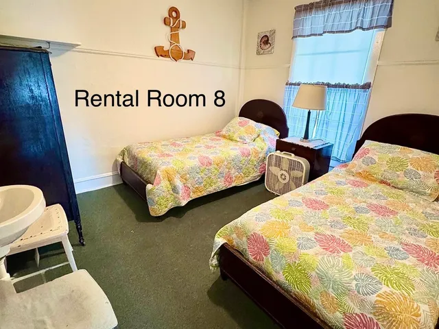 a view of a hallway with wooden floor and entryway