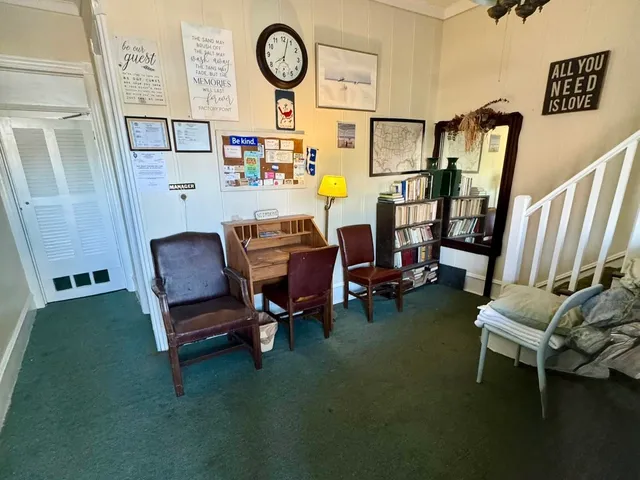 a view of a room with chairs and wooden floor