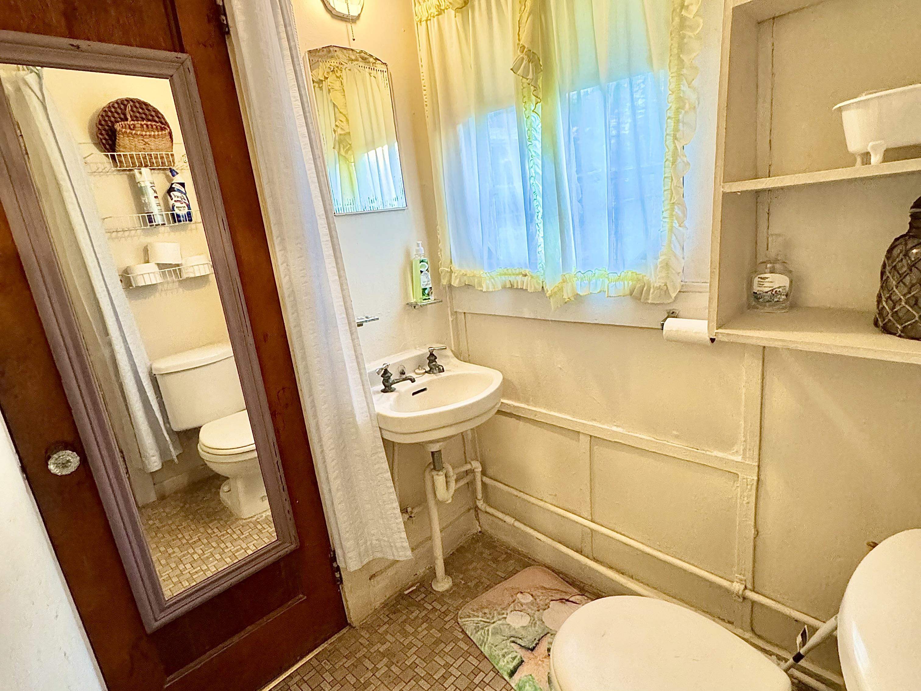 202 Perry Street Cape May, NJ 08204 - Photo 43 of 49 a bathroom with a sink a toilet a mirror and shower