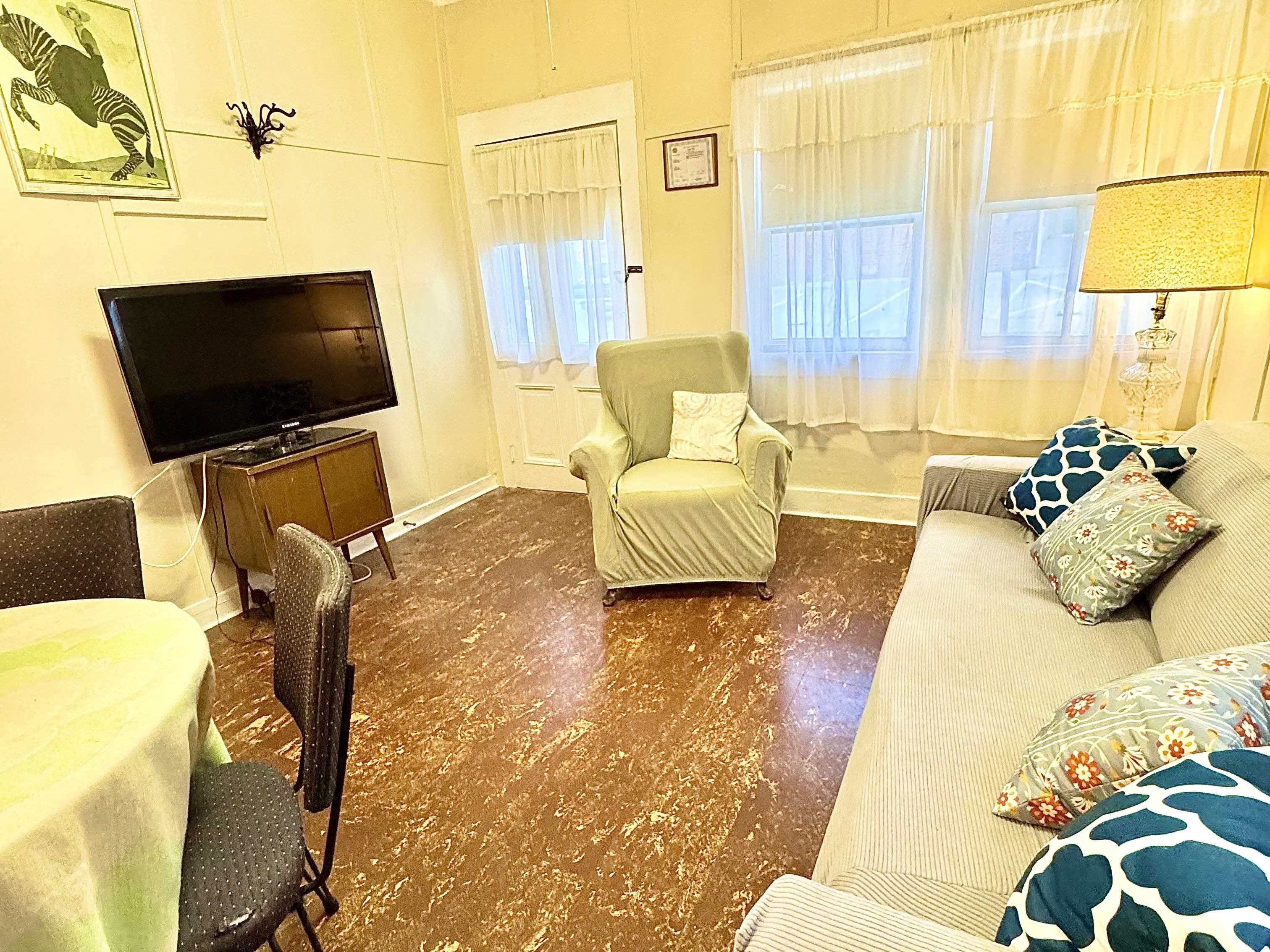 202 Perry Street Cape May, NJ 08204 - Photo 45 of 49 a living room with furniture and a flat screen tv