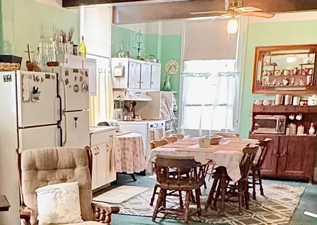 a view of a dining room with furniture and chandelier