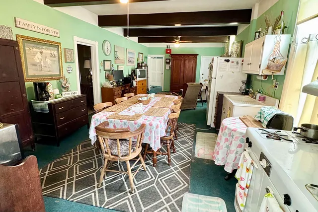 a dining room with furniture and a chandelier