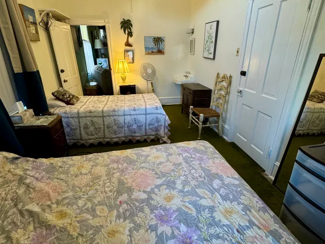 a bedroom with a bed and a flat tv screen on dresser