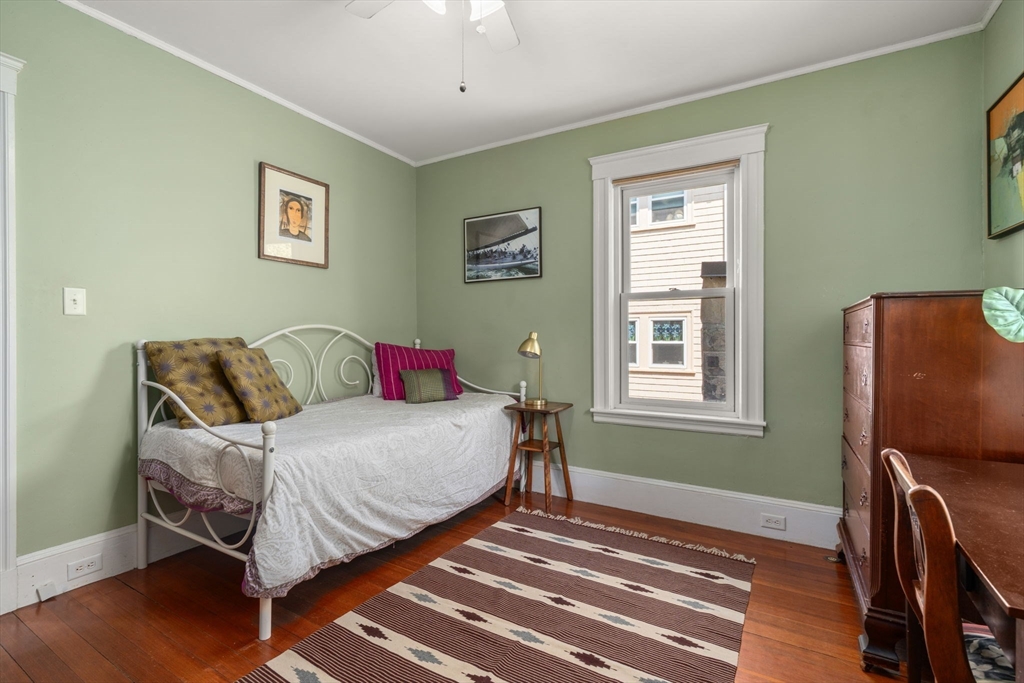 45 Springfield Street, Unit 1 Belmont, MA 02478 - Photo 16 of 27 a bedroom with a bed and wooden floor