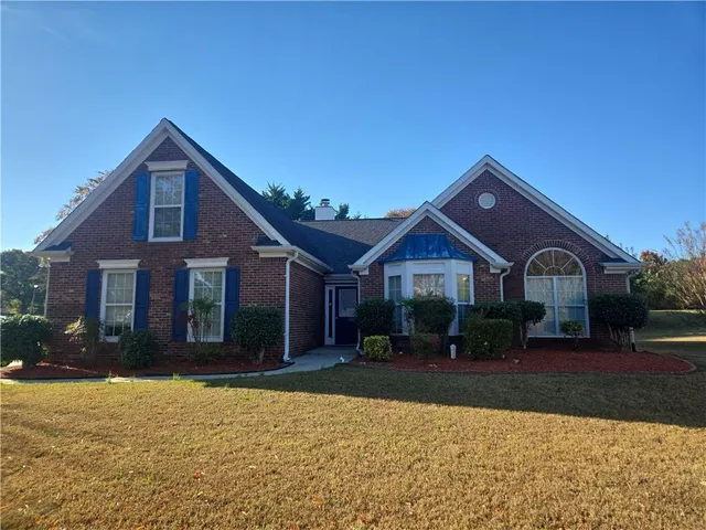a front view of a house with a yard