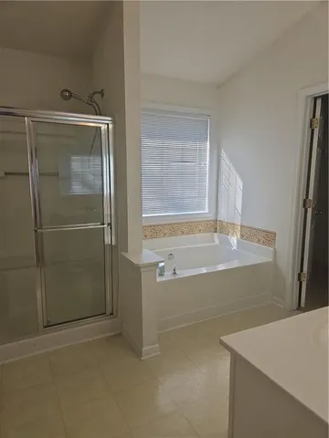 a bathroom with a bathtub and a shower