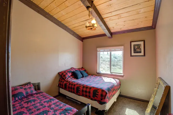 a bedroom with two beds and a chandelier