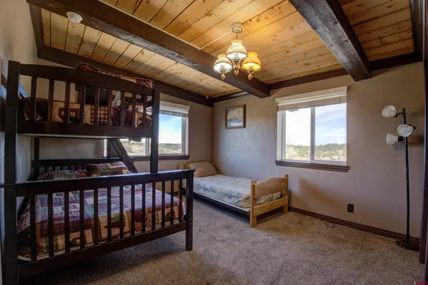 a bedroom with bed and wooden floor