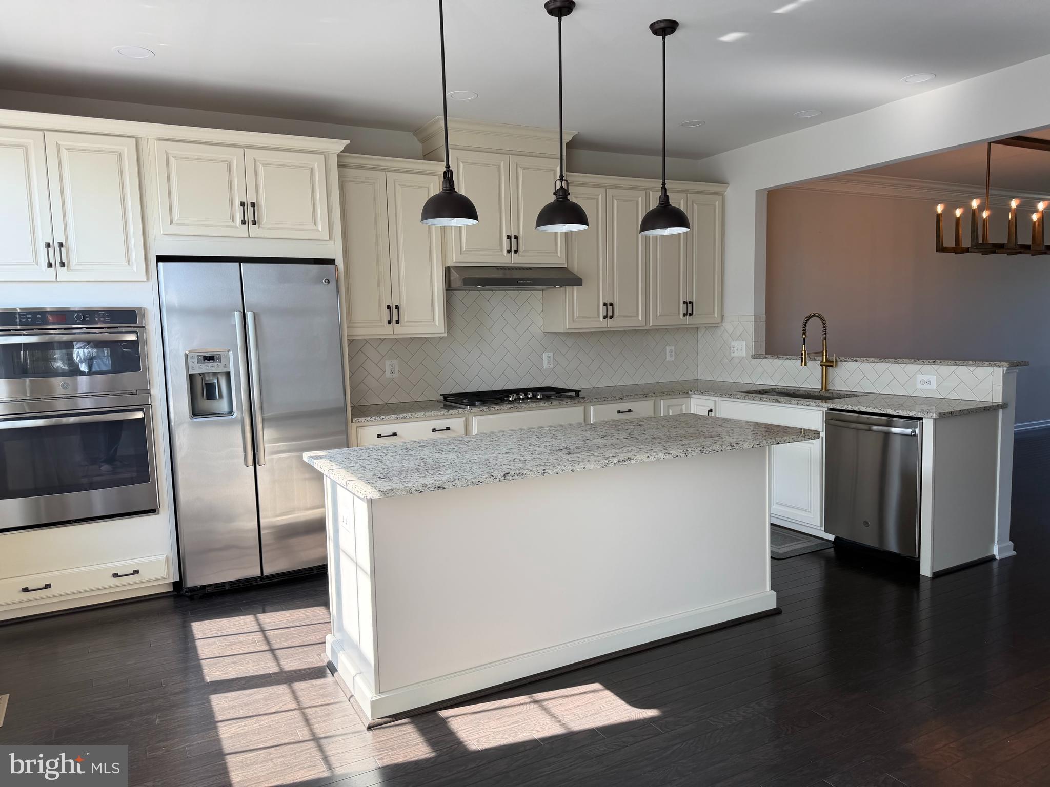 23463 Simms Gap Way Ashburn, VA 20148 - Photo 4 of 10 a kitchen with stainless steel appliances granite countertop a sink a stove and a refrigerator