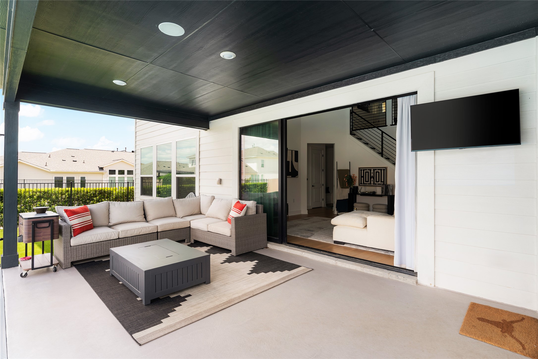 7917 Edmondson Bend Austin, TX 78744 - Photo 19 of 24 Expansive covered patio featuring a black ceiling with recessed lighting, a concrete slab, and a wall-mounted television