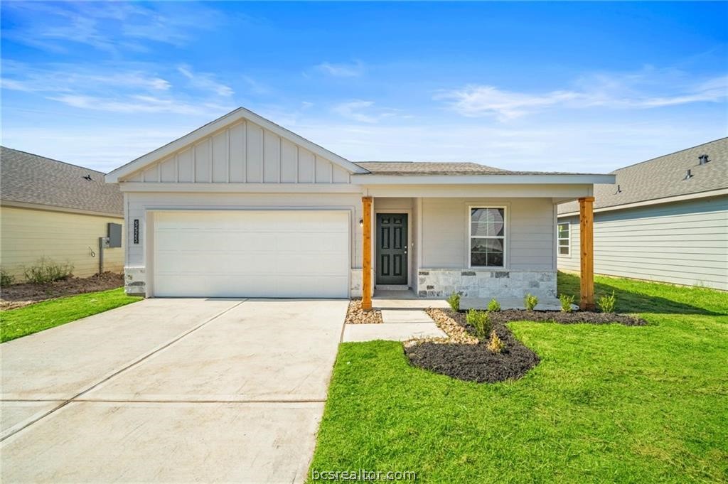 a front view of house with yard and green space