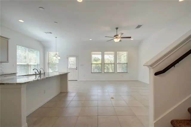 a large white kitchen with a large window