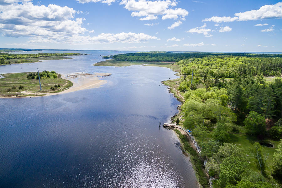 a view of a lake with beach and city view
