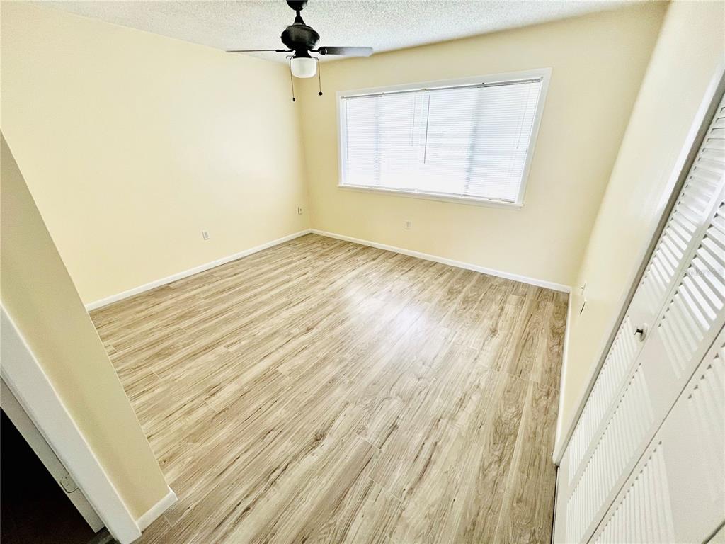 6057 Windhover Drive, Unit E08 Orlando, FL 32819 - Photo 11 of 19 a view of a room with wooden floor and a window