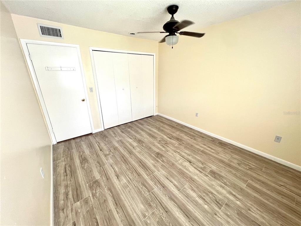 6057 Windhover Drive, Unit E08 Orlando, FL 32819 - Photo 13 of 19 an empty room with a wooden door