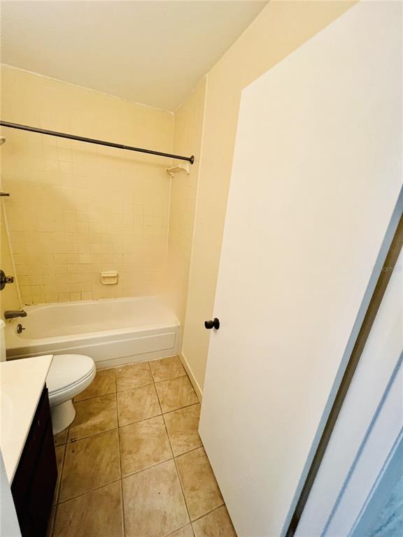 6057 Windhover Drive, Unit E08 Orlando, FL 32819 - Photo 14 of 21 a bathroom with a granite countertop bathtub shower and a toilet