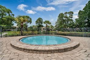 6057 Windhover Drive, Unit E08 Orlando, FL 32819 - Photo 19 of 21 a view of swimming pool with a yard