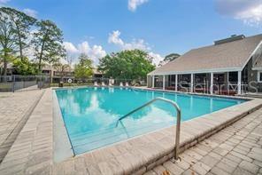 6057 Windhover Drive, Unit E08 Orlando, FL 32819 - Photo 20 of 21 a view of a house with swimming pool next to a yard