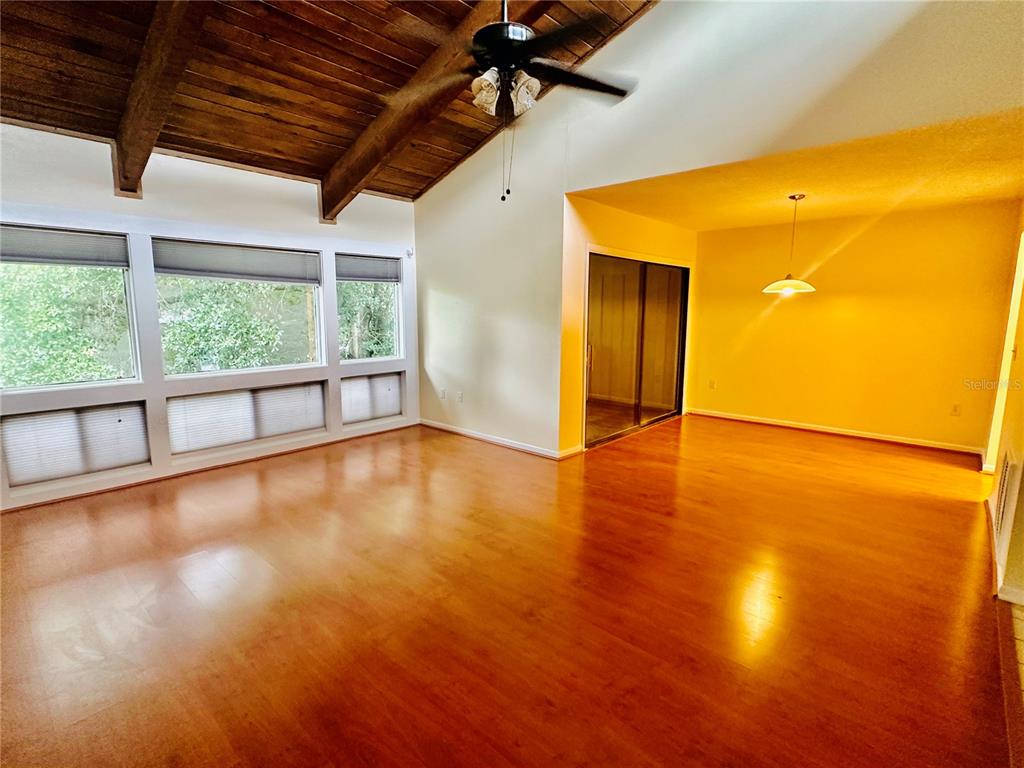 6057 Windhover Drive, Unit E08 Orlando, FL 32819 - Photo 2 of 19 a view of empty room with wooden floor and windows