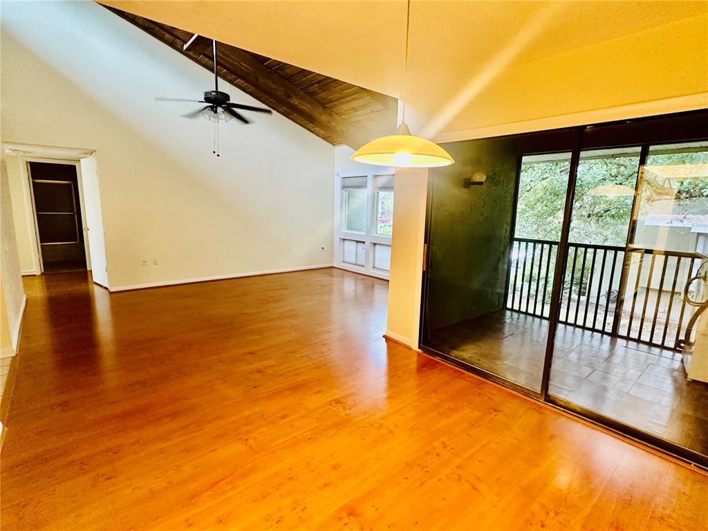 6057 Windhover Drive, Unit E08 Orlando, FL 32819 - Photo 3 of 19 an empty room with wooden floor and windows